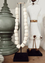 Load image into Gallery viewer, Kenyan Cream Carved Beads - on stand