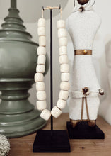 Load image into Gallery viewer, Kenyan Cream Carved Beads - on stand
